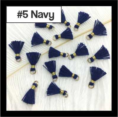 Scattered 1cm navy cotton tassels with gold-tone rings on white fur, labelled #5