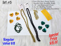 Set #5: faceted gold and green plastic hearts, two rondelle strands, rhinestone chain and needles on white foundation
