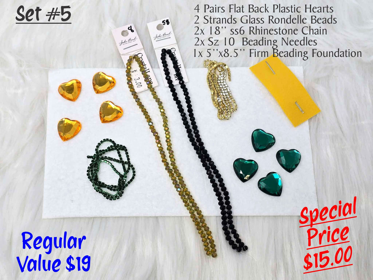 Set #5: faceted gold and green plastic hearts, two rondelle strands, rhinestone chain and needles on white foundation