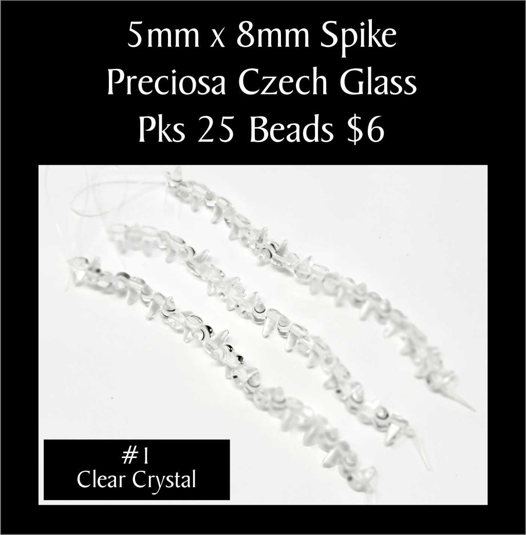 Strands of 5 x 8mm Preciosa Czech glass spike beads in clear crystal, sold in packs of 25