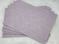 Stack of #62 lilac faux leather sheets embossed with a tooled floral scroll pattern
