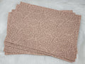 Stack of #65 tan faux leather sheets embossed with a tooled floral scroll pattern