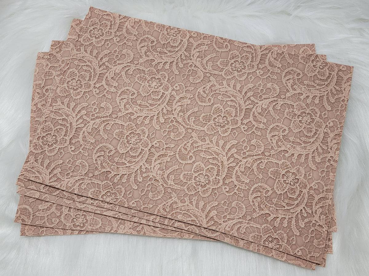 Stack of #65 tan faux leather sheets embossed with a tooled floral scroll pattern