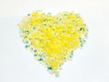 Heart-shaped pile of 6mm iridescent flower sequins in yellow