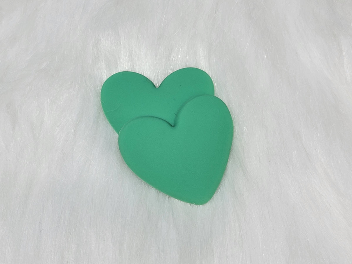 Pair of 37mm matte flexible PVC heart cabochons in #6 Green on white faux fur