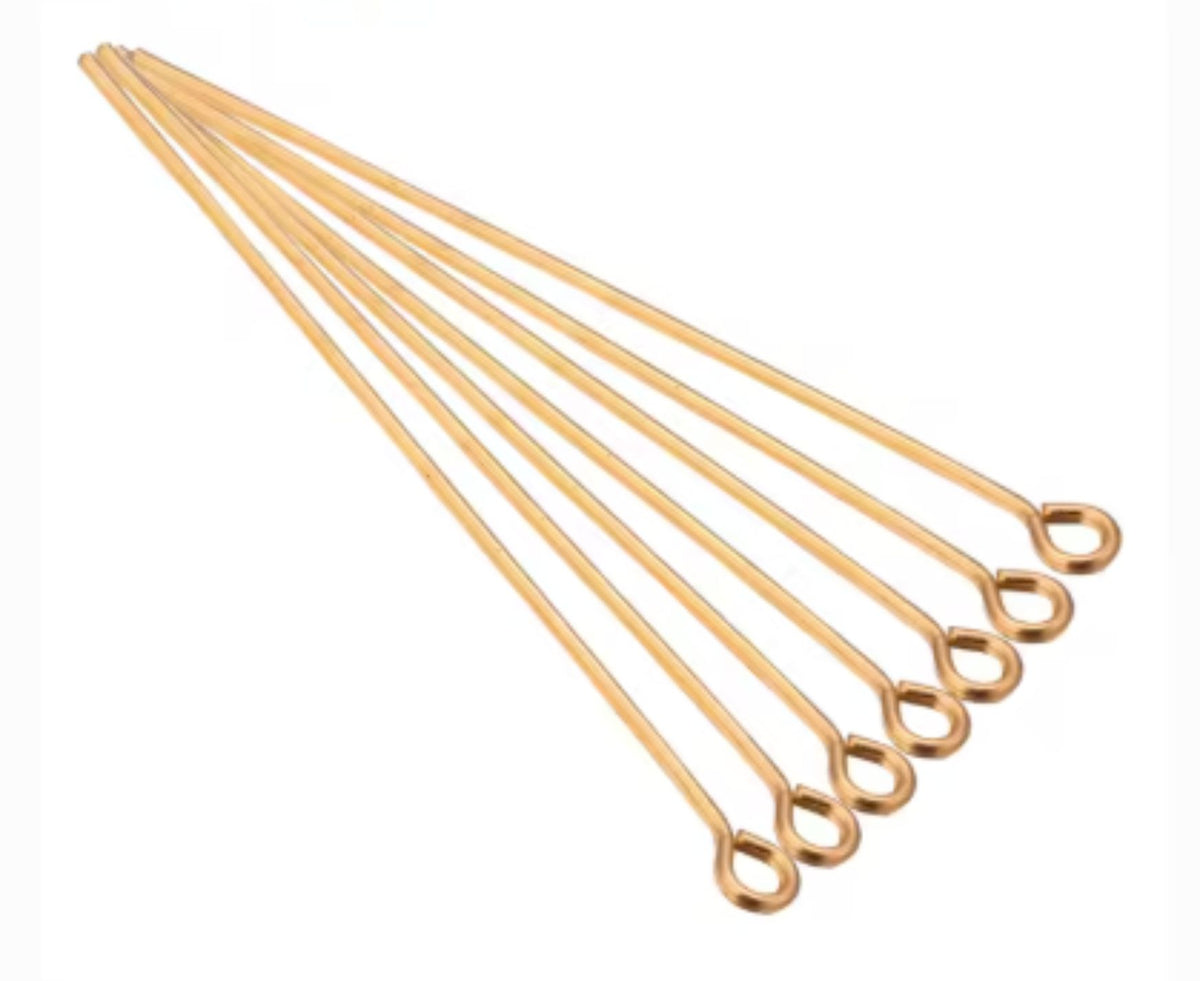 Fan of 70mm KC gold 20 gauge eye pins, each with a small round loop at one end, on white