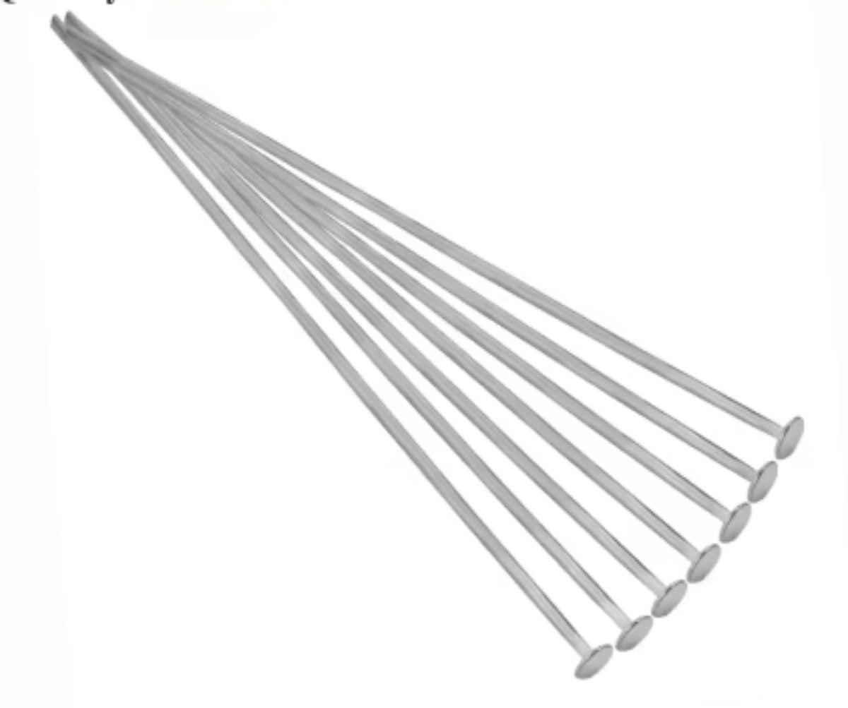 Fan of 70mm rhodium 20 gauge flat head pins, each with a flat disc head at one end, on white