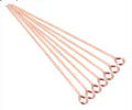 Fan of 70mm rose gold 20 gauge eye pins, each with a small round loop at one end, on white