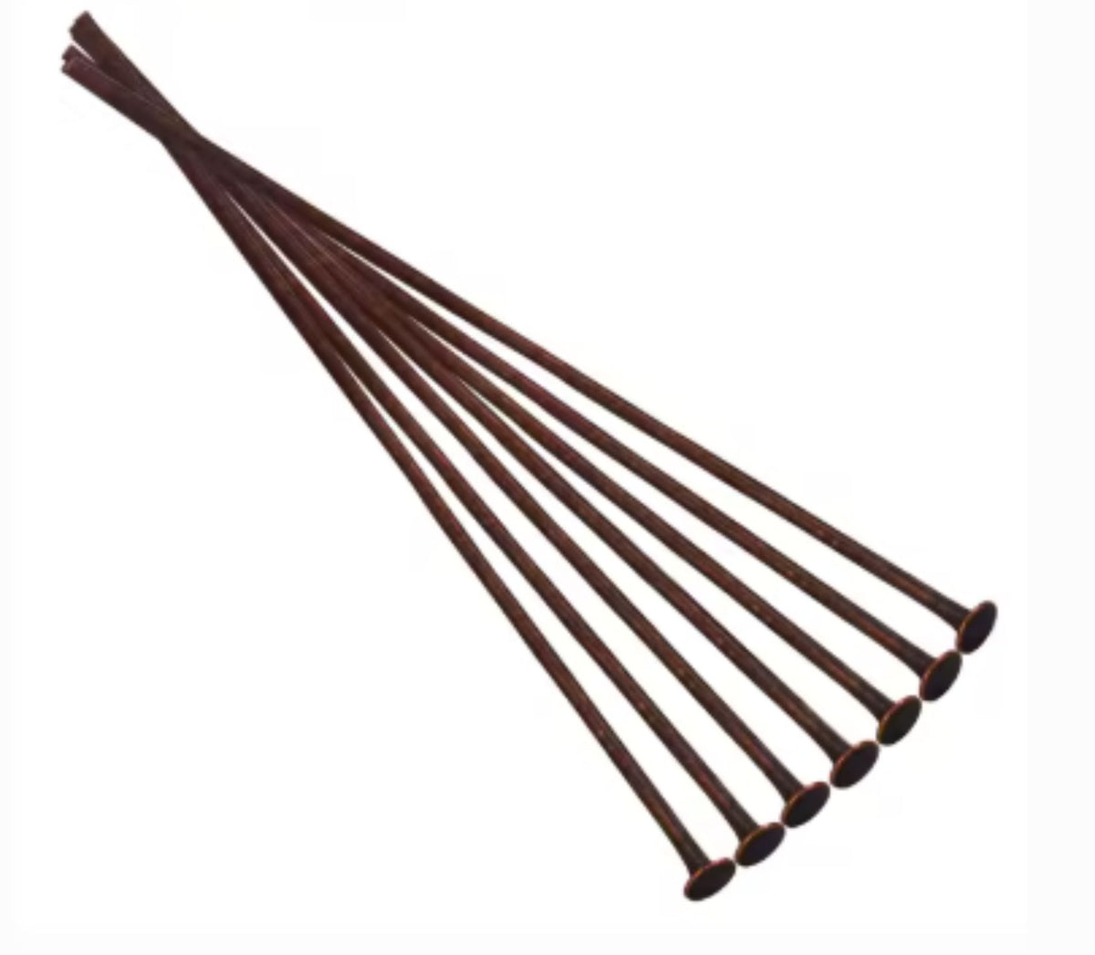 Fan of 70mm copper 20 gauge flat head pins, each with a flat disc head at one end, on white