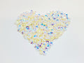 Heart-shaped pile of 6mm iridescent flower sequins in buttercream