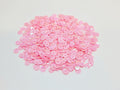 Pile of 6mm round light pink sequins with centre holes, on a white background