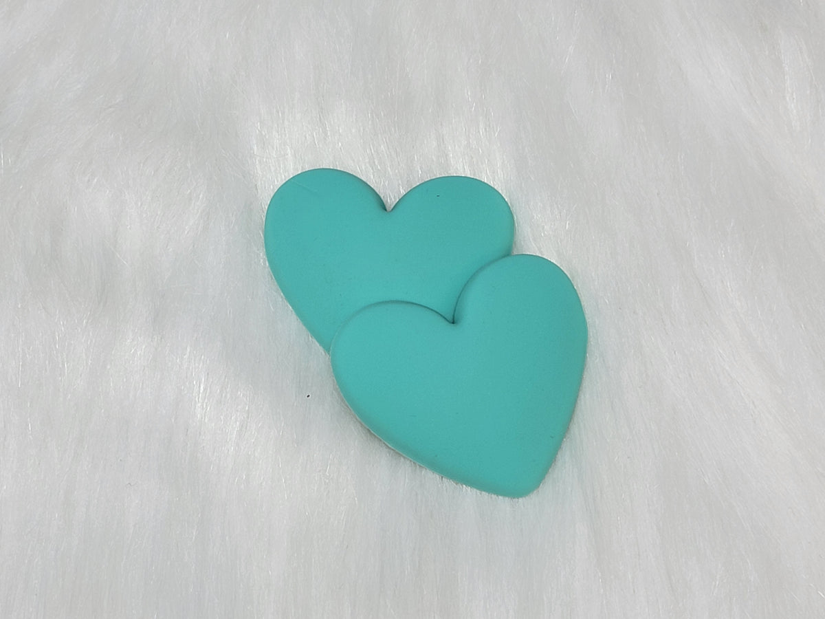 Pair of 37mm matte flexible PVC heart cabs in #7 Turquoise on white faux fur