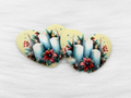 Pair of 37mm resin heart cabochons (cabs) in cream with candles, poinsettias and pine