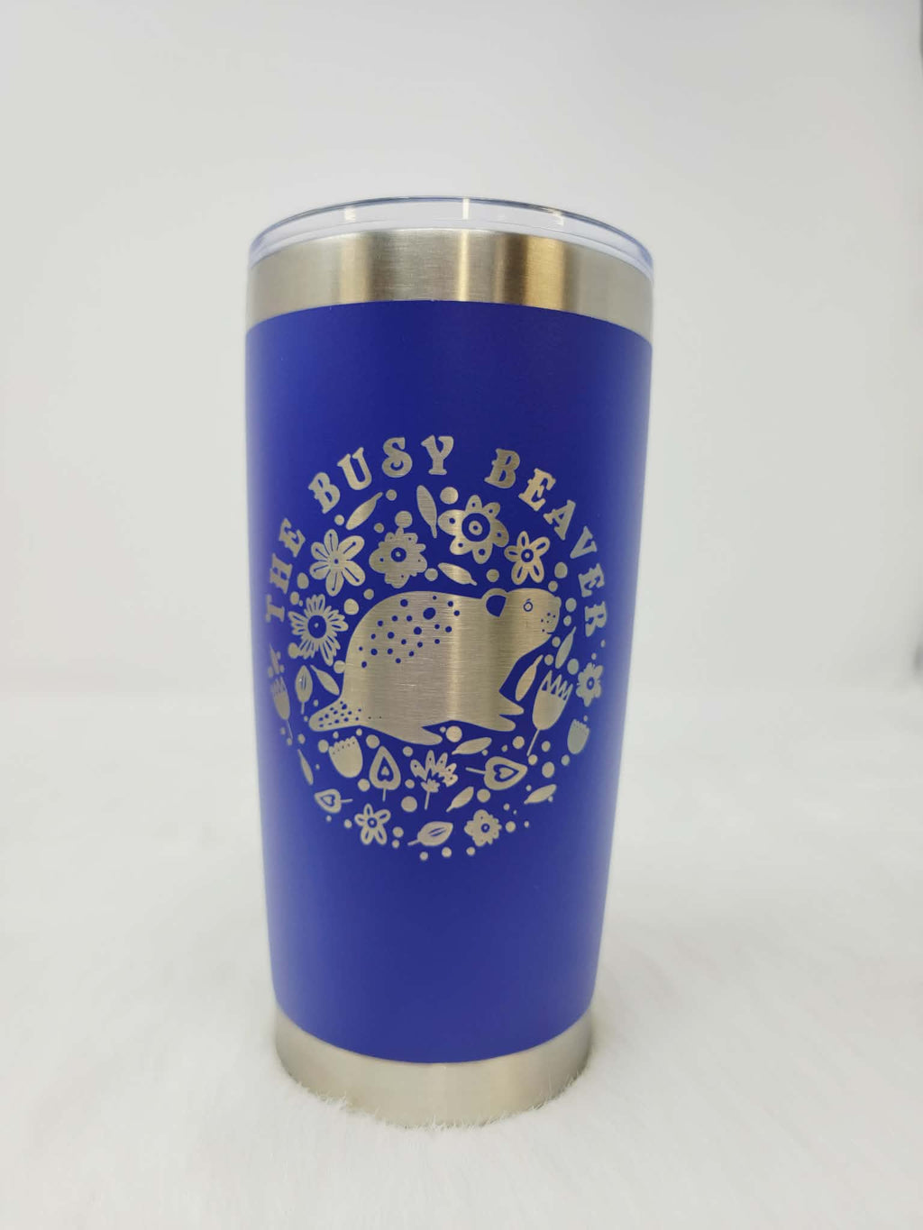 Royal blue stainless steel tumbler engraved with a round floral beaver logo