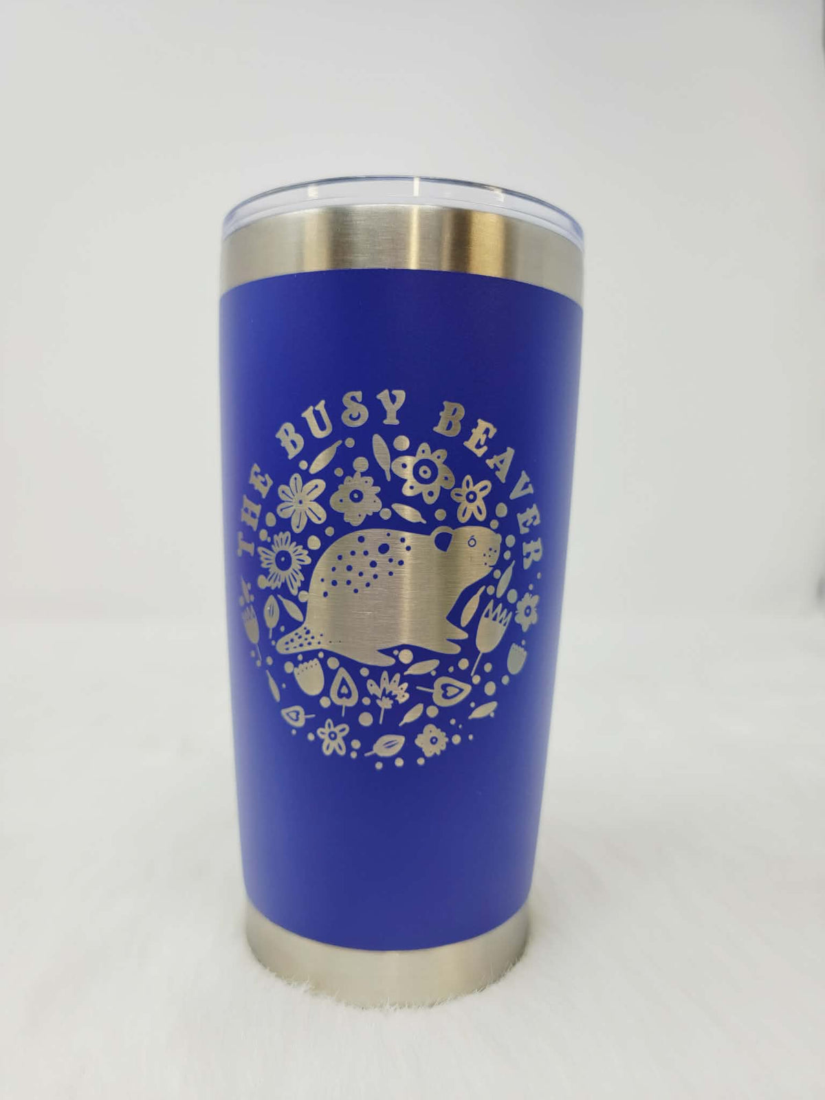 Royal blue stainless steel tumbler engraved with a round floral beaver logo