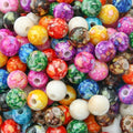 Pile of 8mm round marbled acrylic beads in mixed bright colours