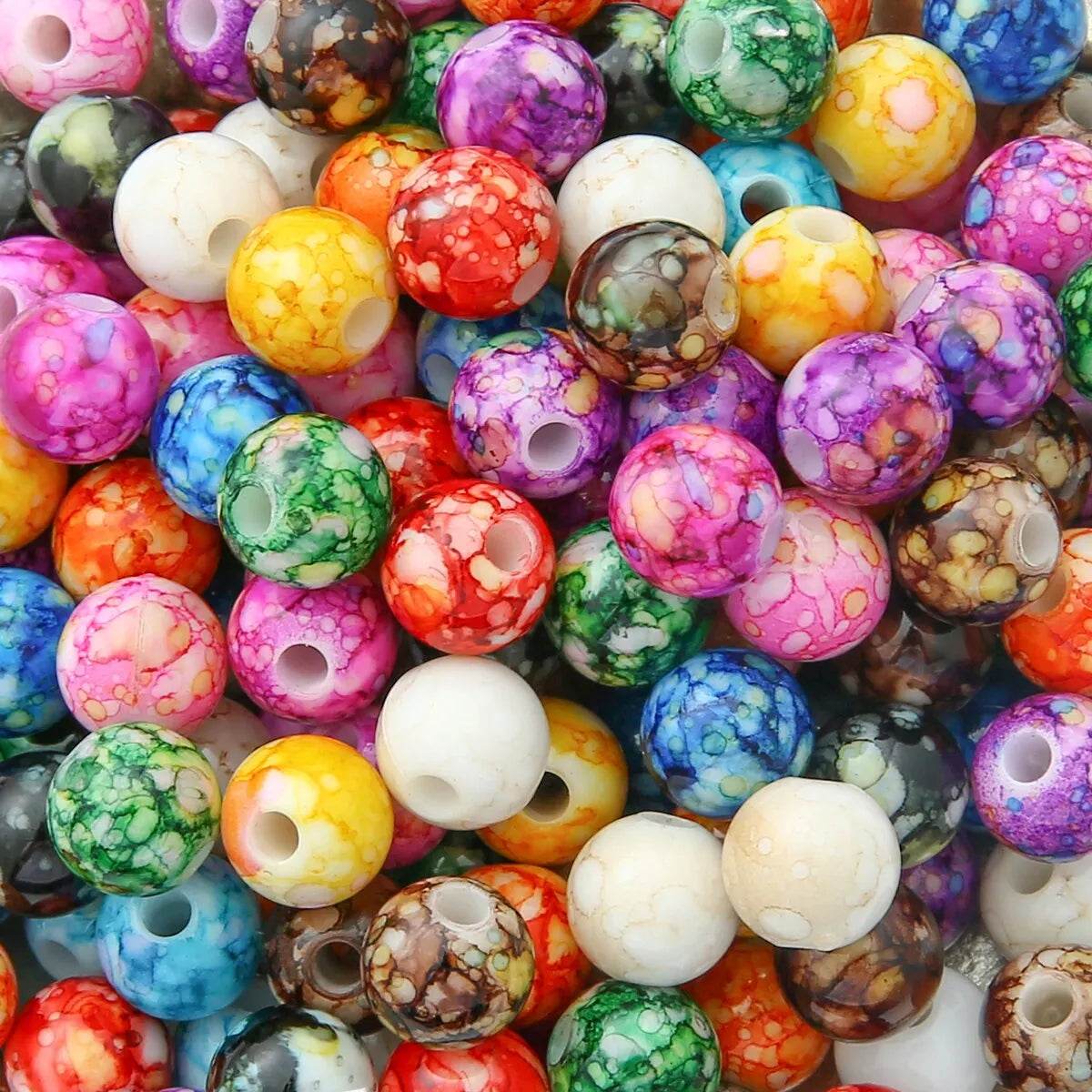 Pile of 8mm round marbled acrylic beads in mixed bright colours