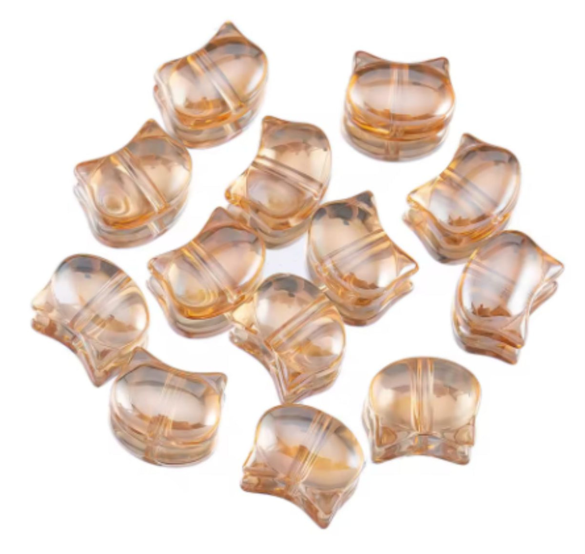 Champagne 8 x 10mm glass cat head beads on a white background