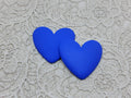 Pair of 37mm matte resin heart cabochons (cabs) in #9 Blue on a grey textured cloth
