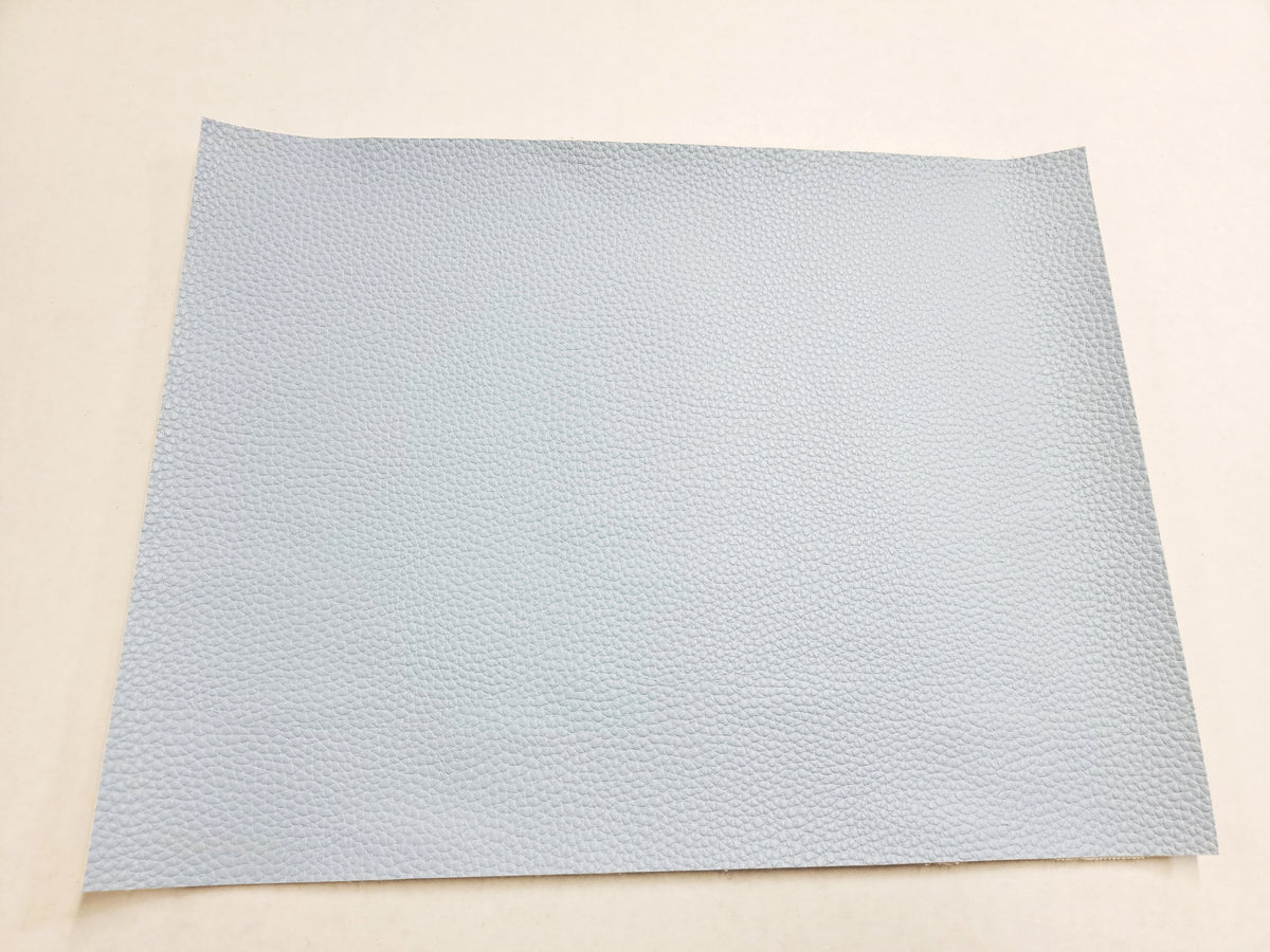 Stack of #9 pale blue faux leather sheets with a pebbled grain texture