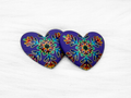 Pair of 37mm resin heart cabochons (cabs) in purple with a rainbow snowflake design