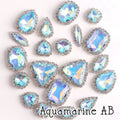 Sew-on crystal rhinestones in aquamarine AB, in 10 shapes with silver claw settings