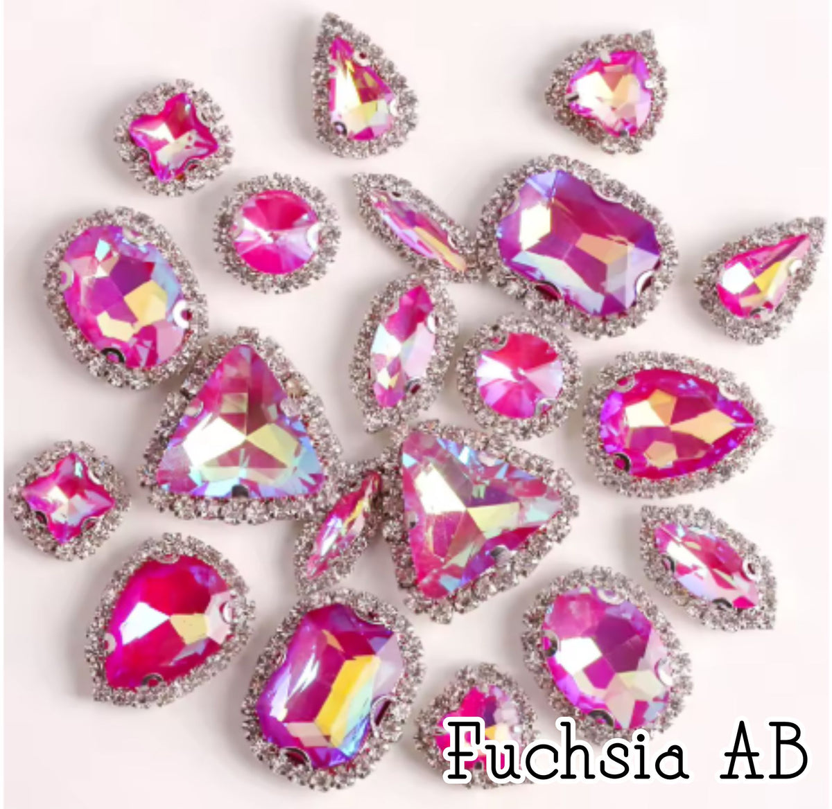 Sew-on crystal rhinestones in fuchsia AB, in 10 shapes with silver claw settings