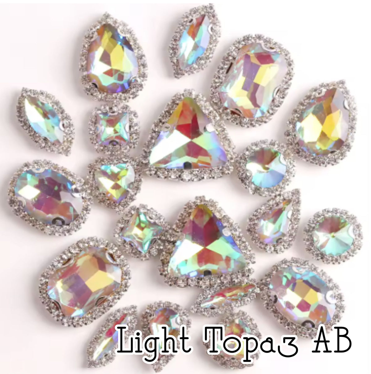 Sew-on crystal rhinestones in light topaz AB, in 10 shapes with silver claw settings