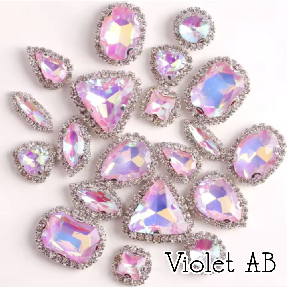 Sew-on crystal rhinestones in violet AB, in 10 shapes with silver claw settings