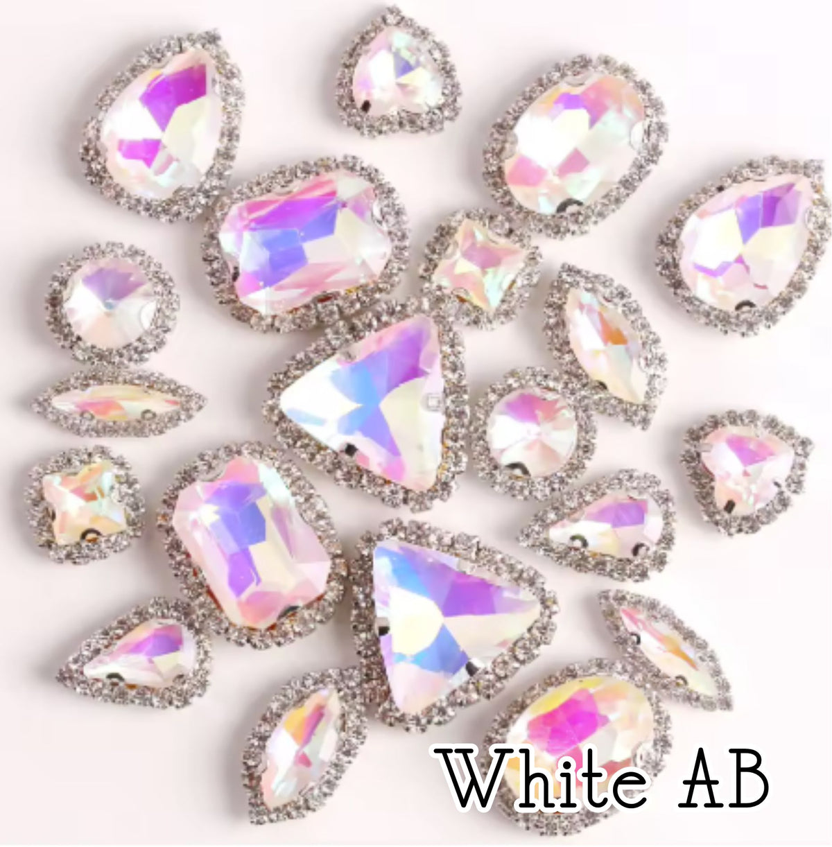 Sew-on crystal rhinestones in white AB, in 10 shapes with silver claw settings