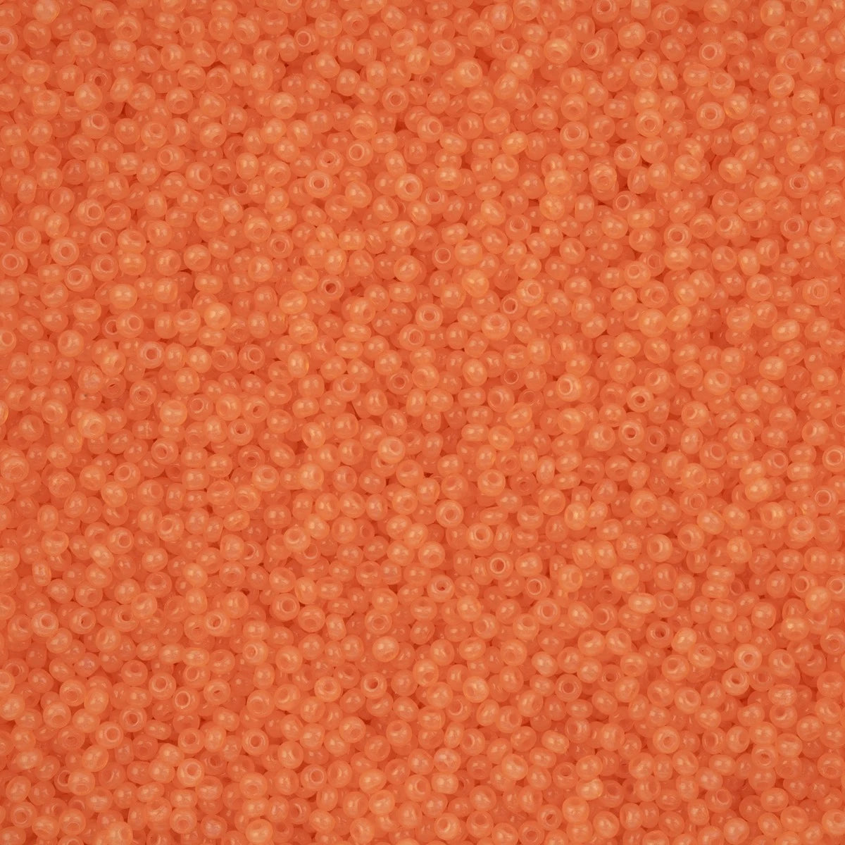 Close-up of Preciosa 11/0 Czech glass seed beads in alabaster orange solgel