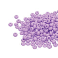 Small pile of Preciosa 11/0 Czech glass seed beads in opaque amethyst solgel on a white background
