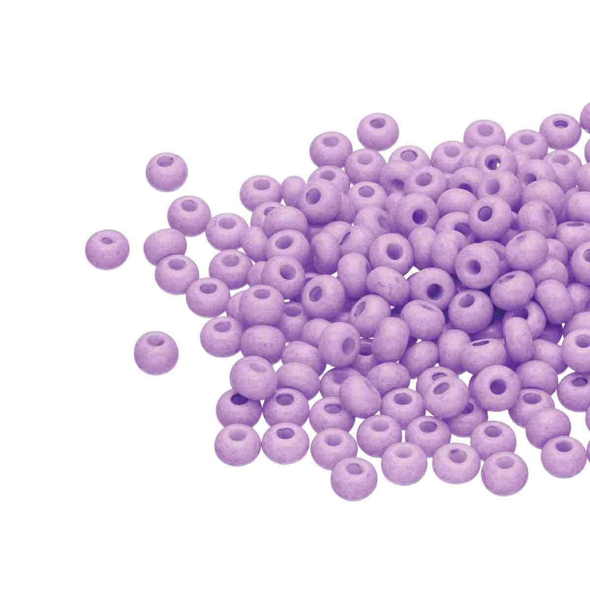 Small pile of Preciosa 11/0 Czech glass seed beads in opaque amethyst solgel on a white background