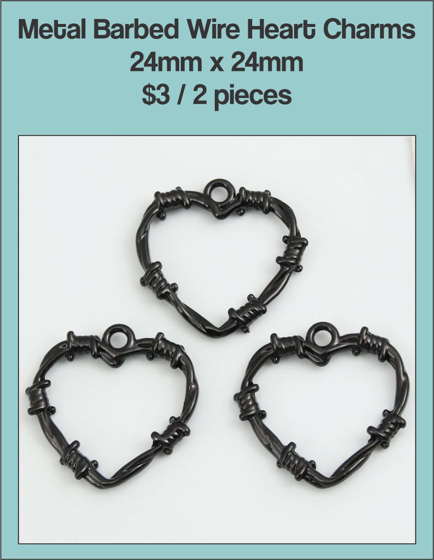 Three black 24mm heart charms shaped like barbed wire on a labelled product card