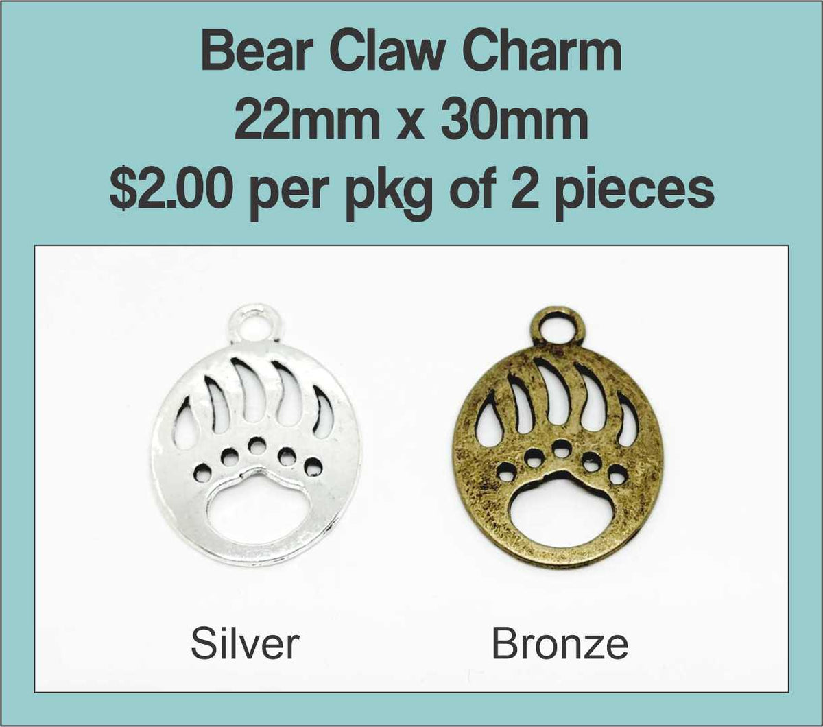 22 x 30mm round bear claw charms in silver and bronze on a labelled product card