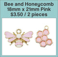 Gold-tone 18 x 21mm bee charm with pink wings beside a pink enamel honeycomb charm