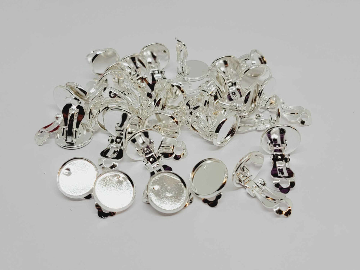 Pile of silver-plated clip-on earrings with 12mm flat round pads