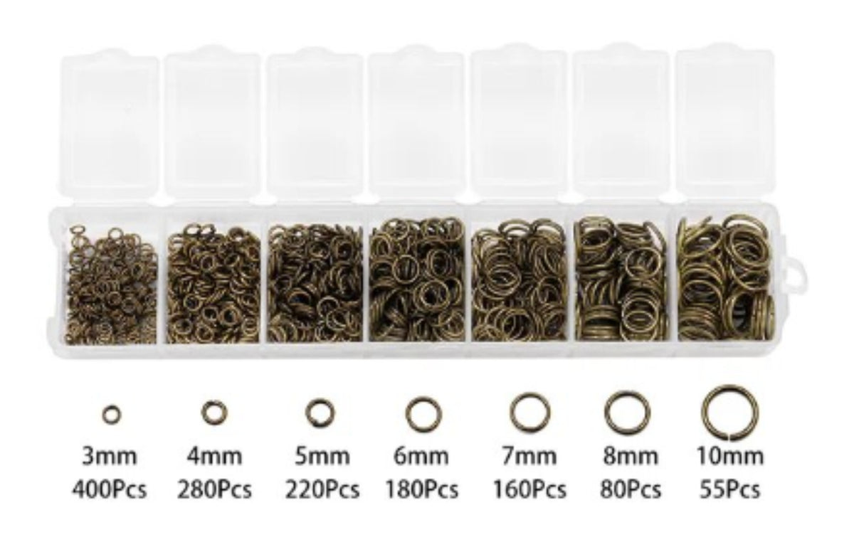 Clear divided case of bronze jump rings in seven sizes from 3mm to 10mm, with size labels