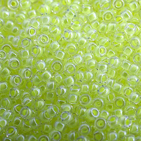 Close-up of Miyuki 11/0 glass seed beads in colour-lined chartreuse luminous neon