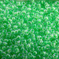 Close-up of Miyuki 11/0 glass seed beads in colour-lined lime green luminous neon