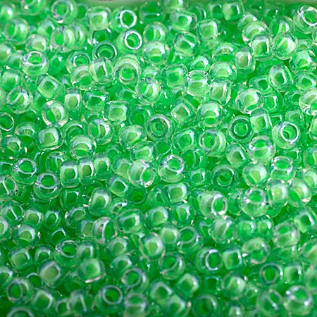 Close-up of Miyuki 11/0 glass seed beads in colour-lined lime green luminous neon