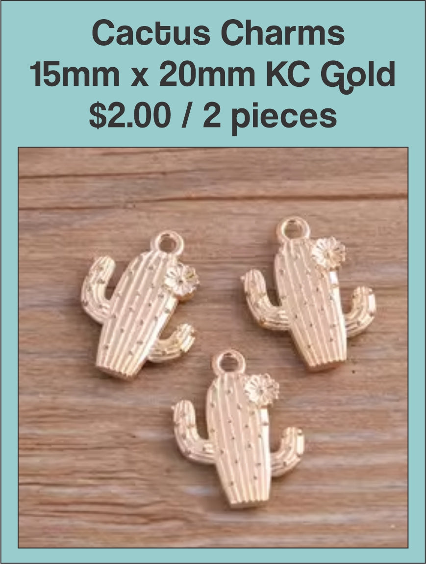 KC gold cactus charms with textured detail on a wood background