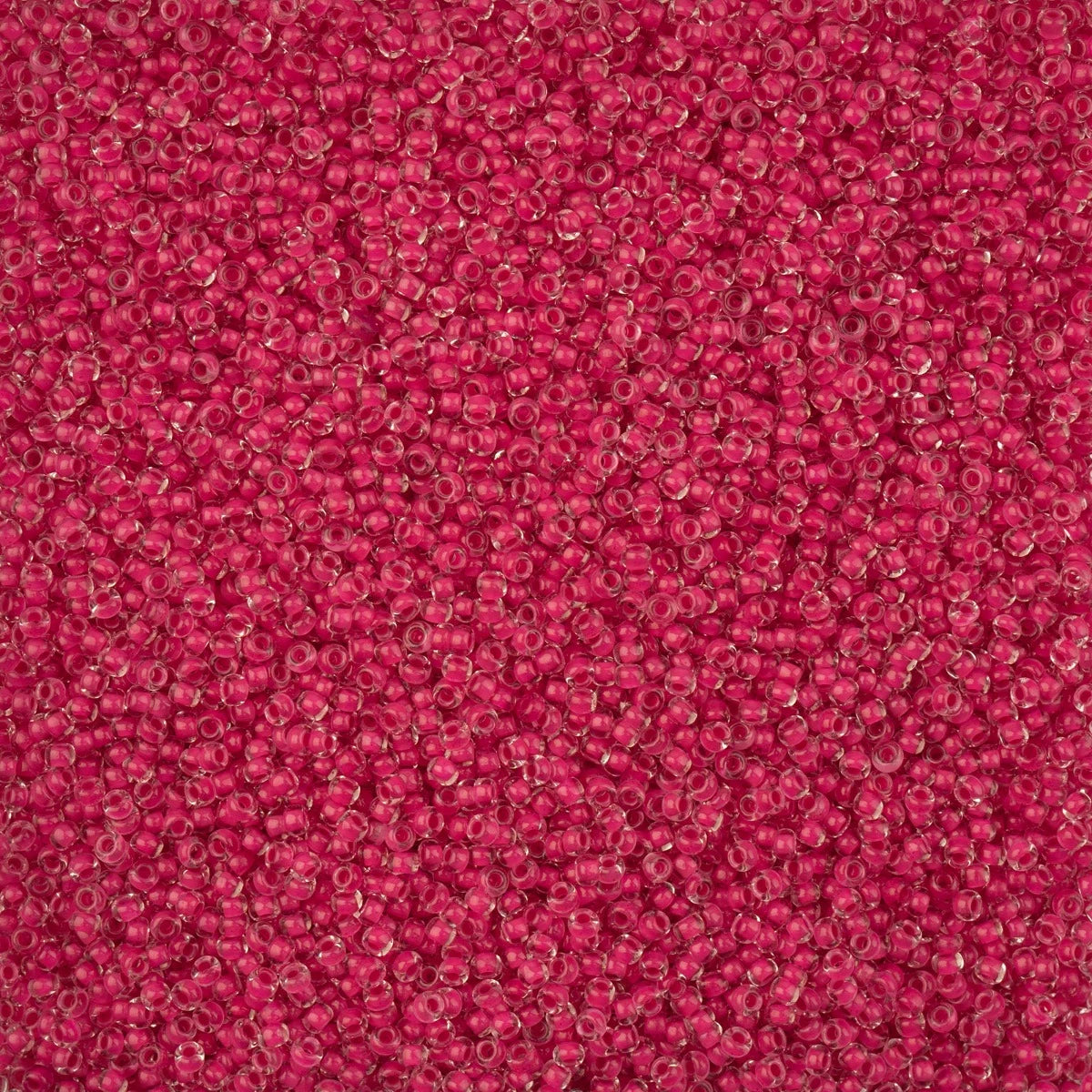 Close-up of Preciosa 11/0 Czech glass seed beads in intensive rose colour-lined terra
