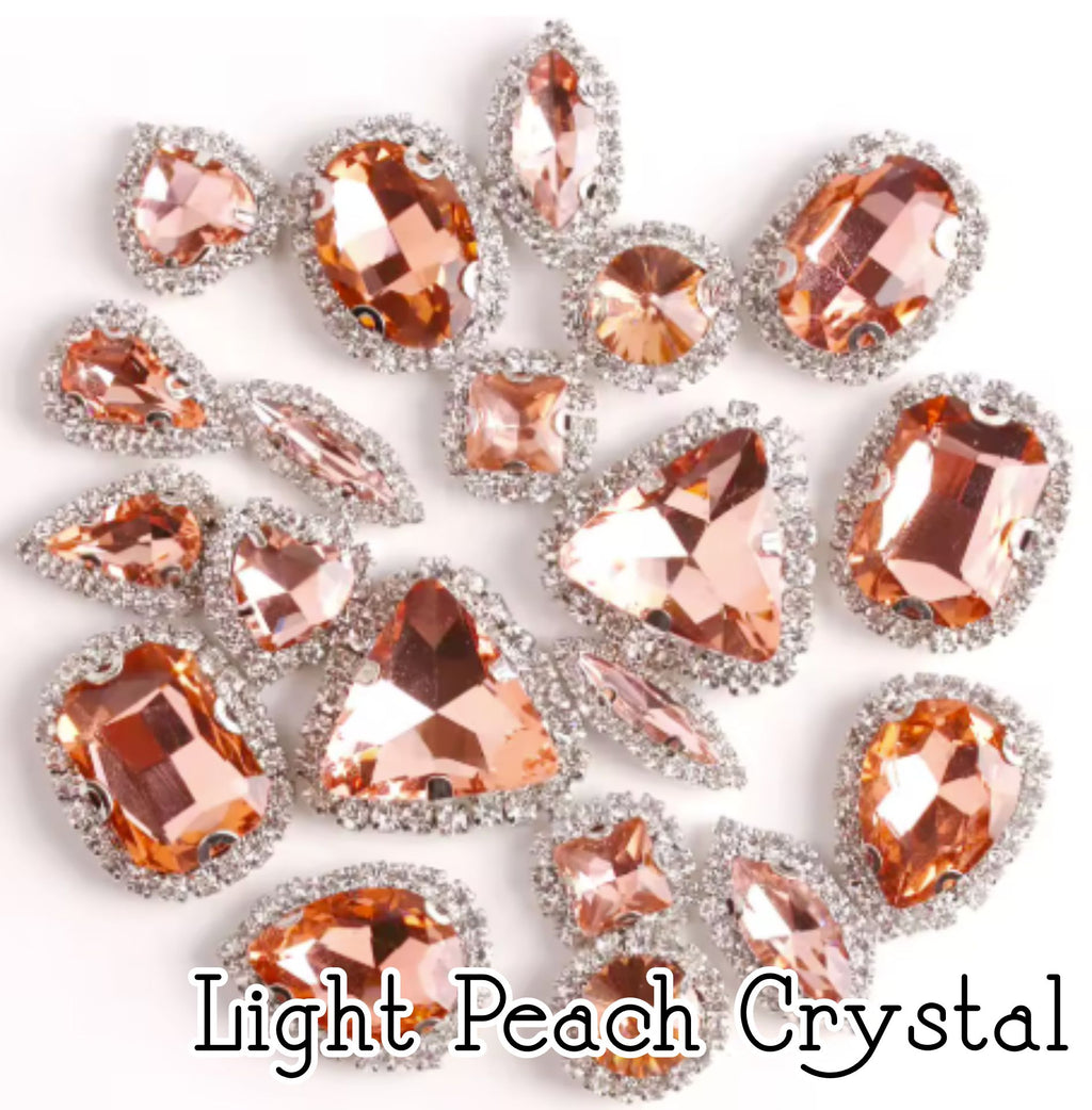 Sew-on crystal rhinestones in light peach crystal, in 10 shapes with silver claw settings