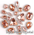 Sew-on crystal rhinestones in light peach crystal, in 10 shapes with silver claw settings