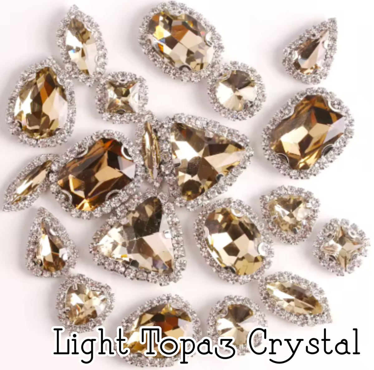 Sew-on crystal rhinestones in light topaz crystal, in 10 shapes with silver claw settings