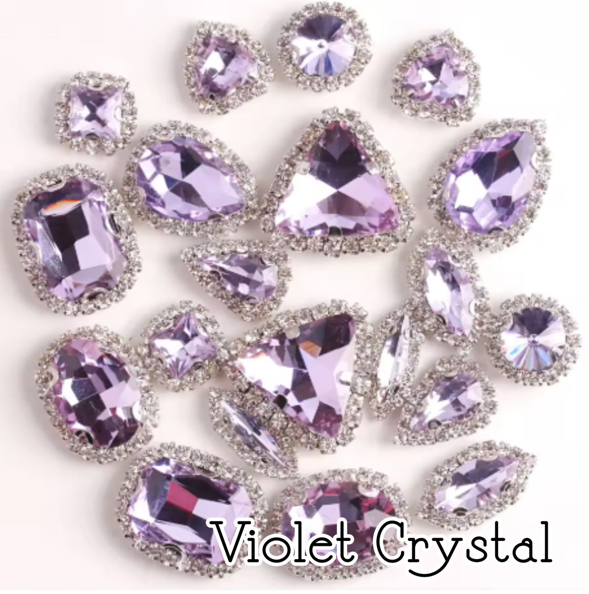 Sew-on crystal rhinestones in violet crystal, in 10 shapes with silver claw settings