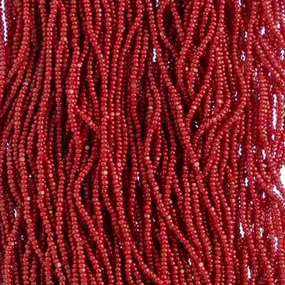 Close-up of strung Preciosa 13/0 true cut charlotte beads in dark red