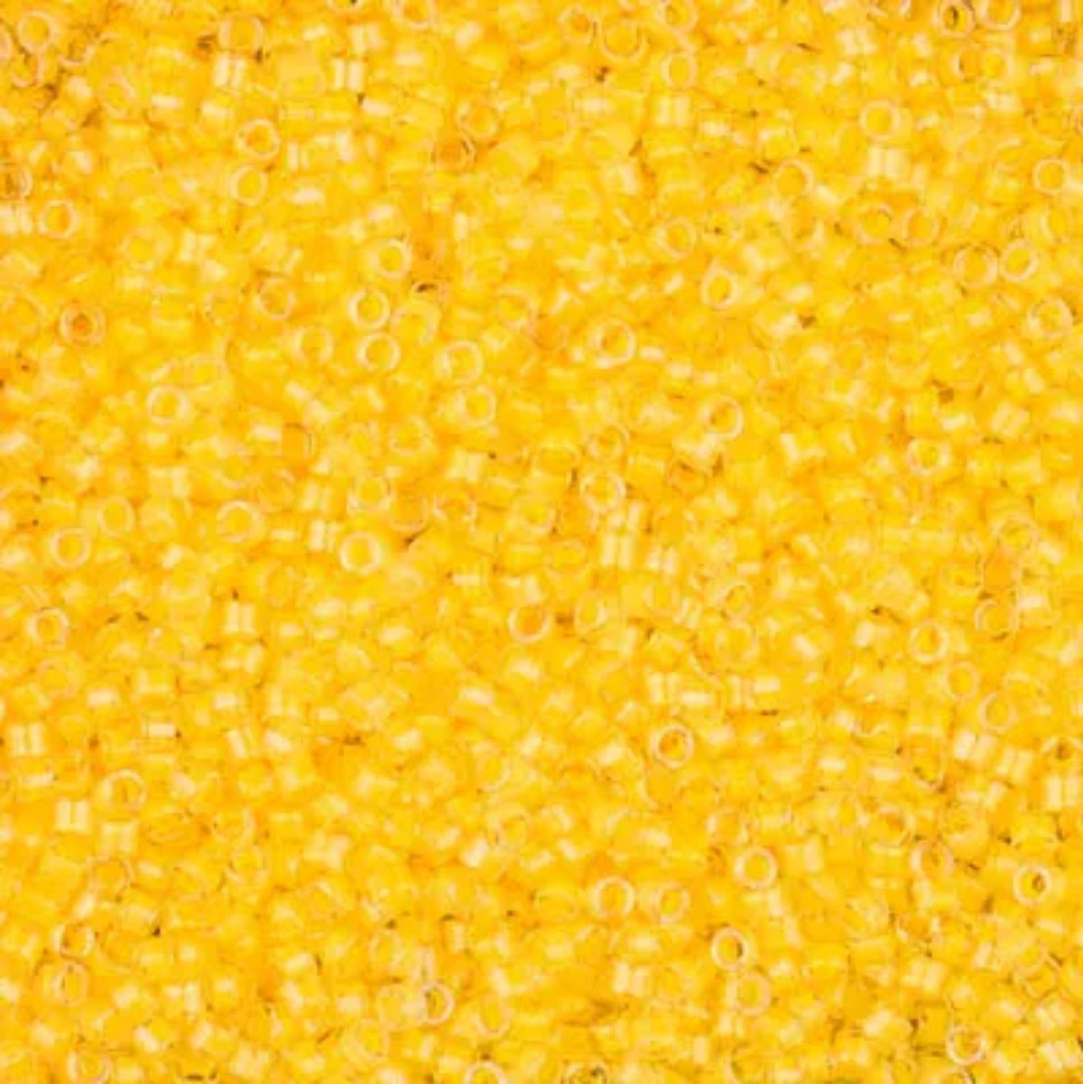 Close-up of Miyuki Delica 11/0 DB2032 cylinder beads in luminous sun glow