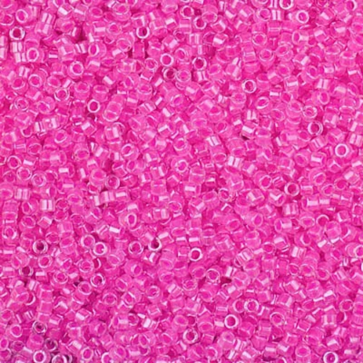 Close-up of Miyuki Delica 11/0 DB2037 cylinder beads in luminous hot magenta